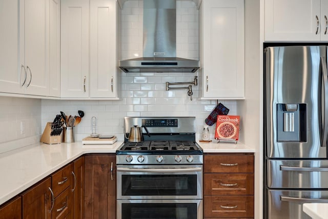 1204 Lakeview Dr # 6, Tomah, WI 54660 - kitchen with stainless steel appliances, wall chimney range hood, light countertops, and white cabinets