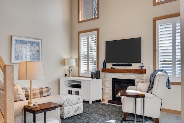 1204 Lakeview Dr # 6, Tomah, WI 54660 - living area featuring a stone fireplace and a high ceiling