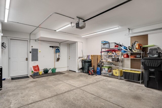 1204 Lakeview Dr # 6, Tomah, WI 54660 - garage featuring electric panel and a garage door opener