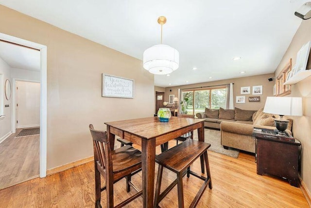 dining room featuring light wood finished floors, baseboards, and recessed lighting