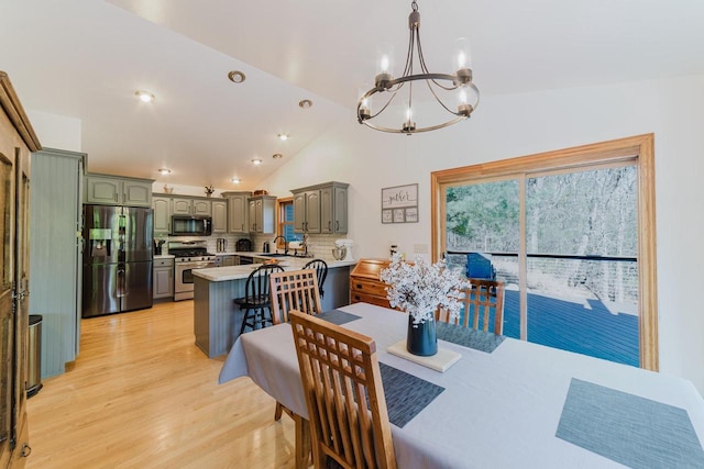 N4404 Pine Dr, Montello, WI 53949 - dining room featuring a chandelier, light wood-style flooring, and lofted ceiling