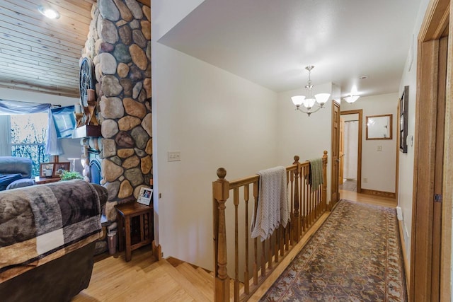 N4404 Pine Dr, Montello, WI 53949 - corridor featuring an upstairs landing, light wood-style floors, a chandelier, and baseboards