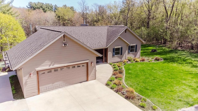 N4404 Pine Dr, Montello, WI 53949 - view of front facade with a front yard, a shingled roof, and a garage