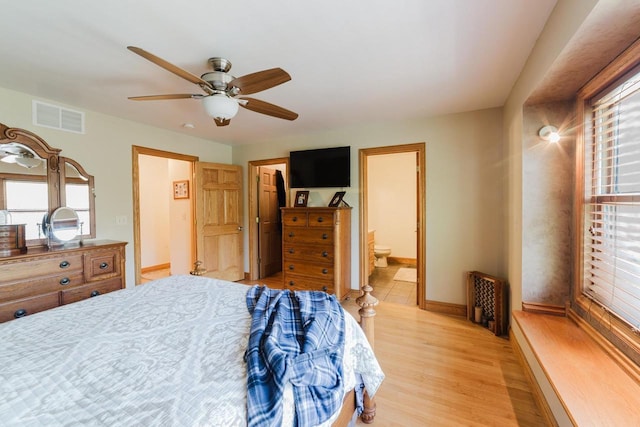 N4404 Pine Dr, Montello, WI 53949 - bedroom featuring multiple windows, light wood-type flooring, baseboards, and ensuite bathroom