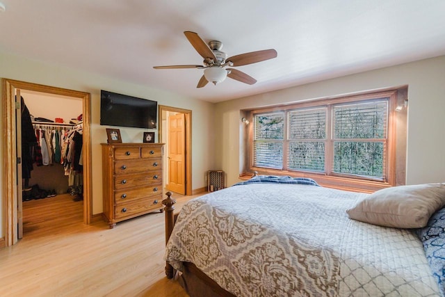 N4404 Pine Dr, Montello, WI 53949 - bedroom with light wood finished floors, a spacious closet, a closet, a ceiling fan, and baseboards