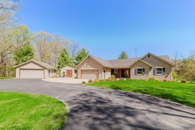 N4404 Pine Dr, Montello, WI 53949 - ranch-style house featuring a front lawn, a garage, and an outdoor structure