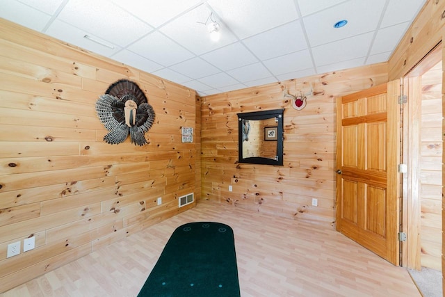 N4404 Pine Dr, Montello, WI 53949 - unfurnished room with light wood-type flooring, wood walls, and a drop ceiling