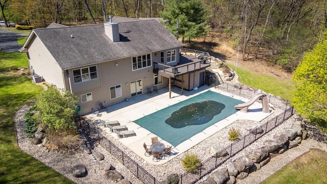 N4404 Pine Dr, Montello, WI 53949 - view of swimming pool featuring a water slide, a deck, fence, and a patio area