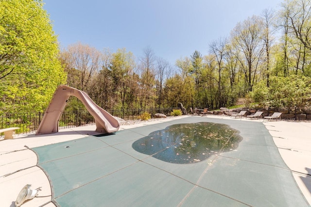 N4404 Pine Dr, Montello, WI 53949 - view of swimming pool with a water slide, fence, and a patio area