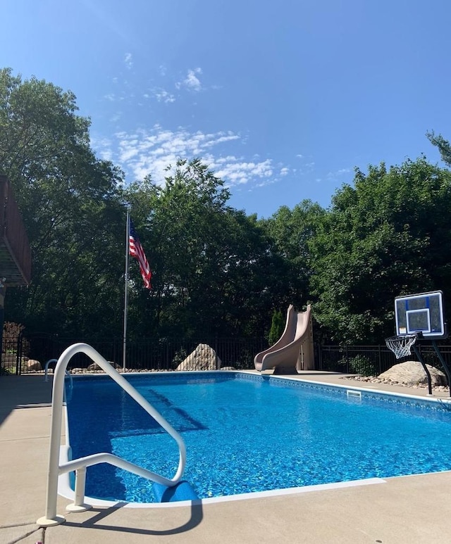 N4404 Pine Dr, Montello, WI 53949 - view of swimming pool with a water slide and fence