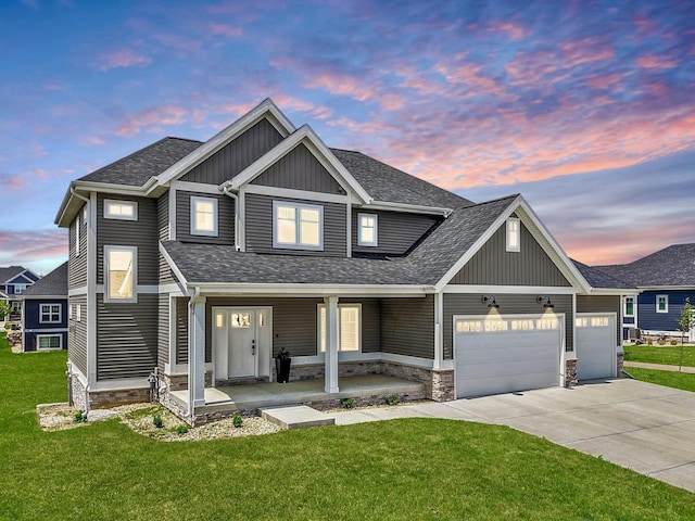 815 Steven Vw, Waunakee, WI 53597 - view of front of property featuring covered porch, board and batten siding, a shingled roof, an attached garage, and a lawn
