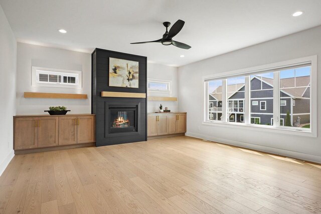 815 Steven Vw, Waunakee, WI 53597 - unfurnished living room with a large fireplace, light wood-style floors, a ceiling fan, baseboards, and recessed lighting