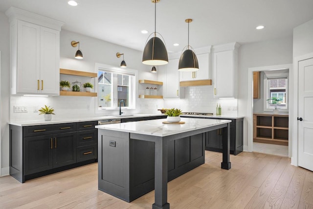 815 Steven Vw, Waunakee, WI 53597 - kitchen featuring open shelves, dark cabinets, a sink, white cabinets, and tasteful backsplash