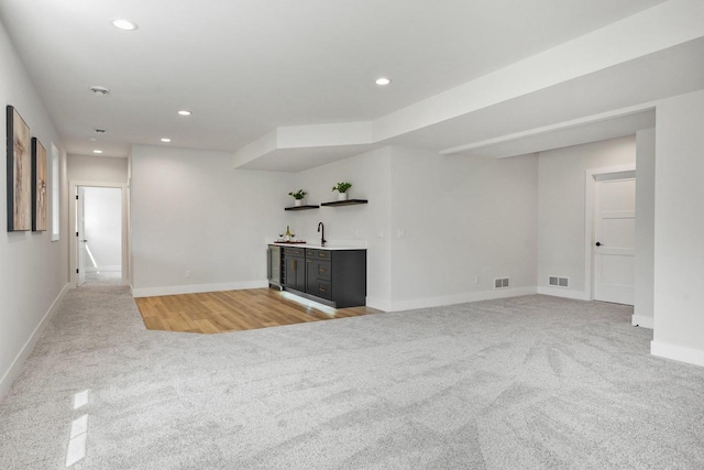815 Steven Vw, Waunakee, WI 53597 - unfurnished living room featuring light carpet, wet bar, baseboards, and recessed lighting