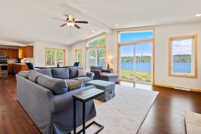 12450 Nixon Rd, Minocqua, WI 54548 - living room with recessed lighting, dark wood-type flooring, ceiling fan, a water view, and baseboards