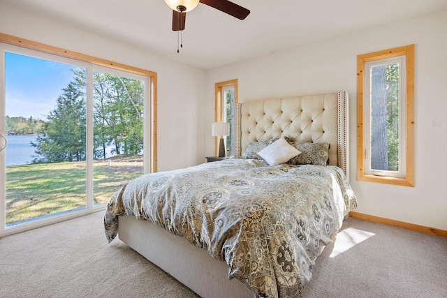 12450 Nixon Rd, Minocqua, WI 54548 - carpeted bedroom with multiple windows, baseboards, and ceiling fan