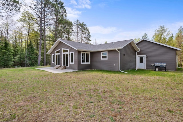 12450 Nixon Rd, Minocqua, WI 54548 - rear view of house featuring a patio, a lawn, and entry steps