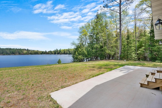 12450 Nixon Rd, Minocqua, WI 54548 - view of grassy yard with a water view, a patio, and a wooded view