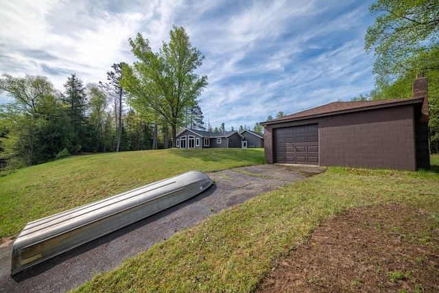 12450 Nixon Rd, Minocqua, WI 54548 - view of green lawn with driveway and a garage