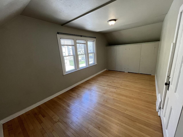 923 E Clarke St, Milwaukee, WI 53212 - bonus room with vaulted ceiling, baseboards, and light wood-style flooring
