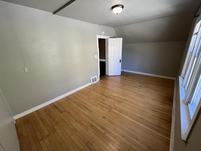 923 E Clarke St, Milwaukee, WI 53212 - empty room with baseboards, lofted ceiling, and light wood finished floors