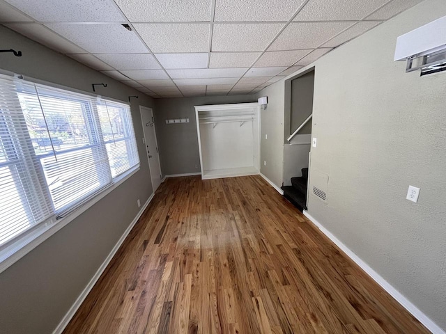 923 E Clarke St, Milwaukee, WI 53212 - unfurnished bedroom with wood finished floors, baseboards, a paneled ceiling, and a closet