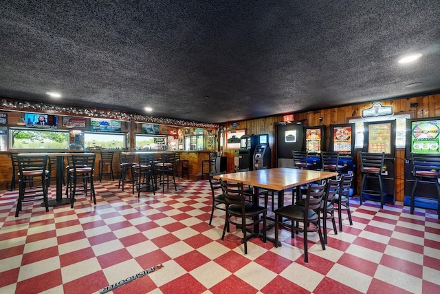 30994 122nd St, New Auburn, WI 54757 - dining space featuring light flooring, a bar, wood walls, and recessed lighting