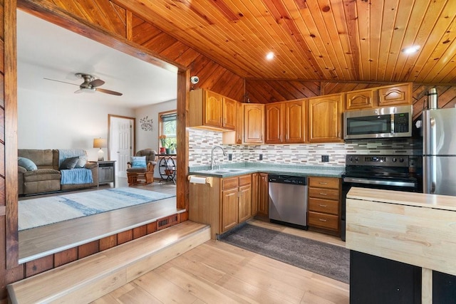 30994 122nd St, New Auburn, WI 54757 - kitchen featuring appliances with stainless steel finishes, a sink, decorative backsplash, vaulted ceiling, and light wood finished floors