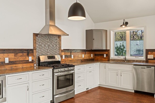 450 Lake Ave, Montello, WI 53949 - kitchen with appliances with stainless steel finishes, island exhaust hood, a sink, dark stone countertops, and lofted ceiling