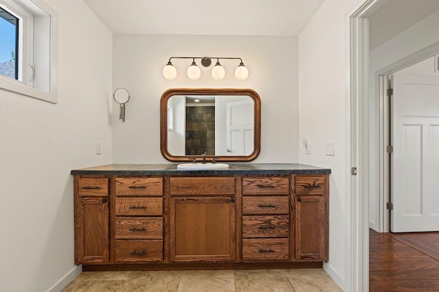 450 Lake Ave, Montello, WI 53949 - bathroom with baseboards, vanity, and tiled shower
