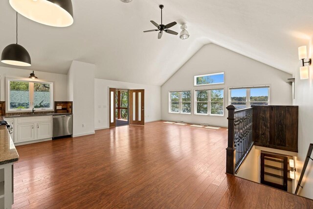 450 Lake Ave, Montello, WI 53949 - unfurnished living room with wood finished floors, plenty of natural light, a sink, ceiling fan, and high vaulted ceiling