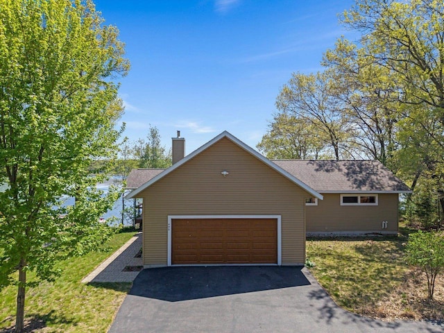 450 Lake Ave, Montello, WI 53949 - view of front of property with driveway, a chimney, an attached garage, and a front yard