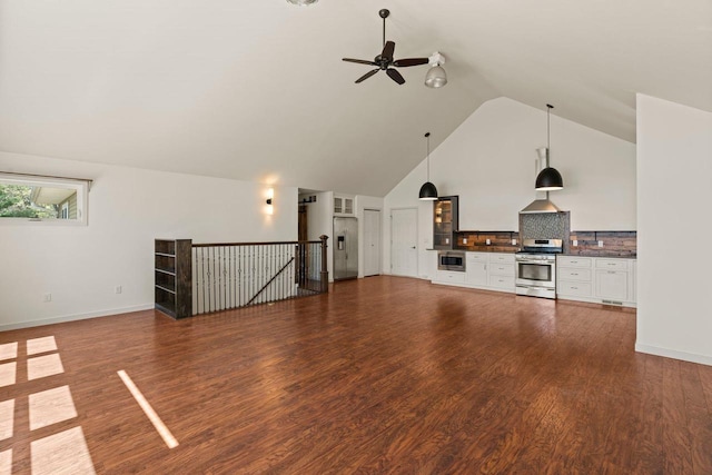450 Lake Ave, Montello, WI 53949 - unfurnished living room featuring ceiling fan, high vaulted ceiling, dark wood-type flooring, and baseboards