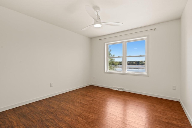 450 Lake Ave, Montello, WI 53949 - empty room with wood finished floors, a ceiling fan, and baseboards