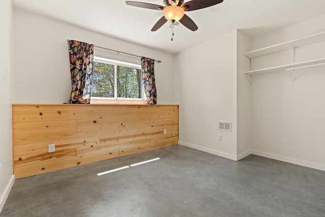 450 Lake Ave, Montello, WI 53949 - unfurnished bedroom with concrete floors, baseboards, and a ceiling fan