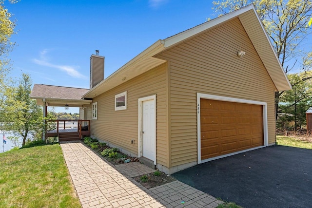 450 Lake Ave, Montello, WI 53949 - view of side of property with a chimney, an outdoor structure, and a deck