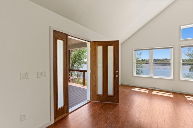 450 Lake Ave, Montello, WI 53949 - entryway with wood-type flooring, baseboards, high vaulted ceiling, and a water view