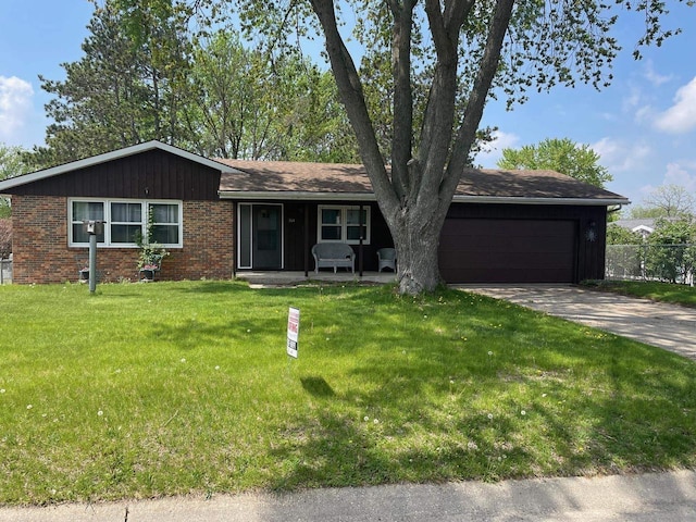 864 Suellen Ln, Portage, WI 53901 - ranch-style home with a garage, driveway, brick siding, and a porch