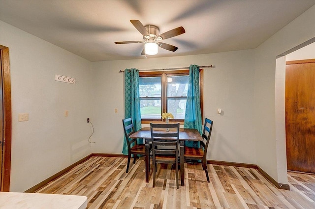 864 Suellen Ln, Portage, WI 53901 - dining room with light wood-type flooring, baseboards, and a ceiling fan