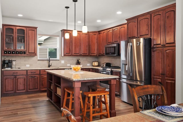 6102 Misty Bridge Rd, Madison, WI 53718 - kitchen featuring stainless steel appliances, a sink, decorative backsplash, dark wood-style flooring, and recessed lighting