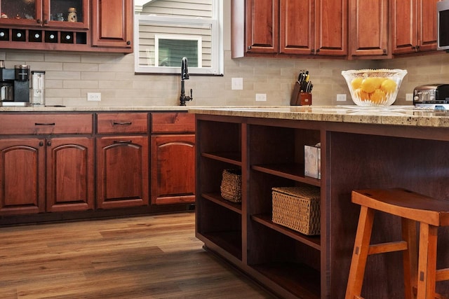 6102 Misty Bridge Rd, Madison, WI 53718 - kitchen with open shelves, tasteful backsplash, stainless steel microwave, dark wood finished floors, and a sink