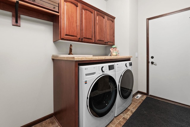 6102 Misty Bridge Rd, Madison, WI 53718 - washroom featuring separate washer and dryer, cabinet space, light tile patterned floors, and baseboards