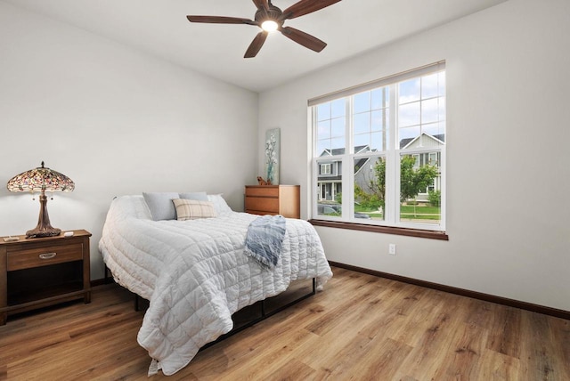 6102 Misty Bridge Rd, Madison, WI 53718 - bedroom with baseboards, wood finished floors, and a ceiling fan