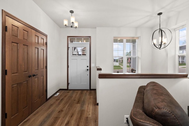 6102 Misty Bridge Rd, Madison, WI 53718 - entryway with a chandelier, dark wood finished floors, and baseboards