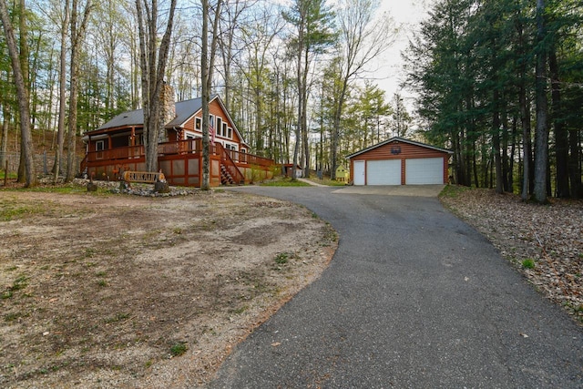 N12665 Hemlock Shores Ct, Athelstane, WI 54104 - view of side of property featuring a detached garage, an outbuilding, a deck, and stairs