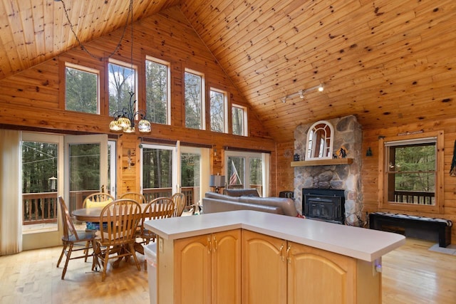 N12665 Hemlock Shores Ct, Athelstane, WI 54104 - kitchen featuring high vaulted ceiling, open floor plan, light countertops, wooden ceiling, and a fireplace