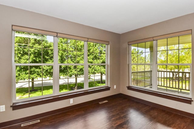 494 Woodfield Cir, Waterford, WI 53185 - empty room with baseboards and dark wood-style flooring