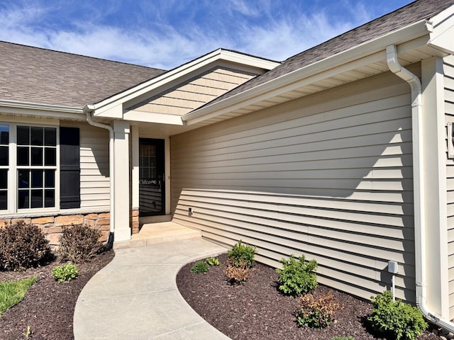 494 Woodfield Cir, Waterford, WI 53185 - entrance to property featuring roof with shingles and stone siding