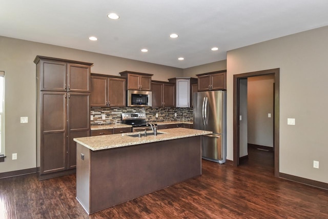 494 Woodfield Cir, Waterford, WI 53185 - kitchen featuring appliances with stainless steel finishes, dark wood-style floors, baseboards, a sink, and recessed lighting