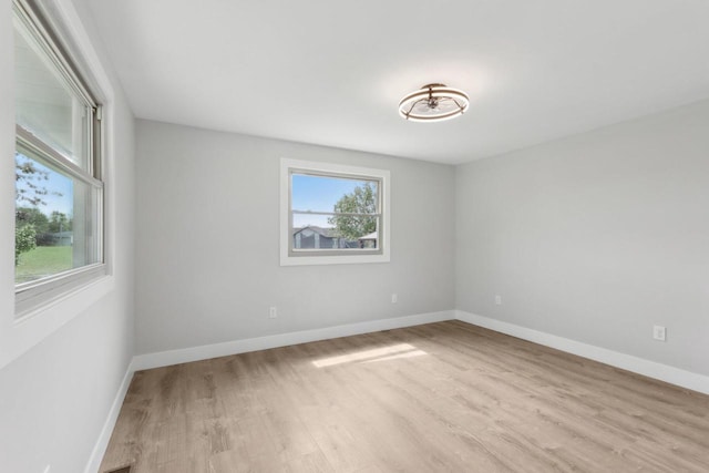 4012 25th Pl, Kenosha, WI 53144 - empty room featuring healthy amount of natural light, wood finished floors, and baseboards